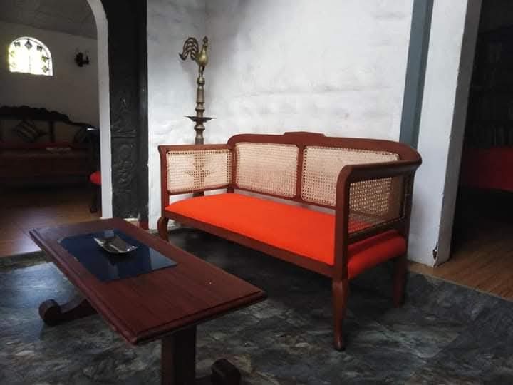 Long cane settee before restoration